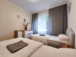 a hotel room with two beds and a window at Family Suites & Parking in Baden-Baden