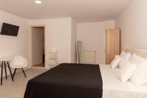 a bedroom with a large bed with white pillows at Sea Oasis Residence in Limenas