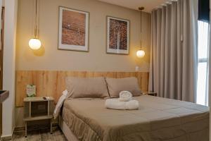 a bedroom with a bed with two towels on it at Cerritos Premium Tower & Mall in Pereira +65 photos