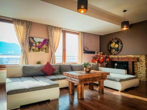 a living room with a couch and a table at Apartments Sofia - Luxury Penthouse in Liptovský Mikuláš
