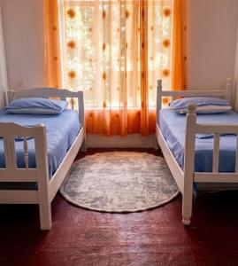two twin beds in a room with a window at Old Town Casa in Ulcinj