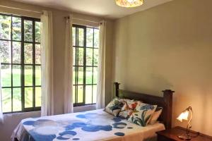 a bedroom with a bed and two windows at Villa Sulterra in Tambor +32 photos