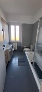a bathroom with a tub and a toilet and a sink at casArona in Arona +10 photos