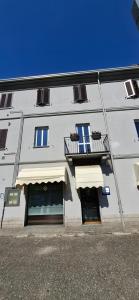 a white building with two windows and a balcony at casArona in Arona