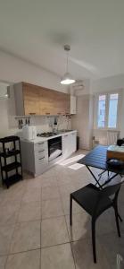a large kitchen with a table and a dining room at casArona in Arona