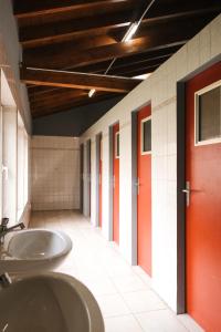a bathroom with two sinks and a red door at Yurt Mongolia - Camp La Belle Vie in Berdorf +20 photos