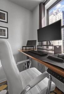 an office with a desk with a computer and a chair at Lavish Columbus Circle Manhattan Apartment by Central Park & Times Square ADULTS ONLY in New York