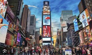 a crowd of people crossing a busy city street at Lavish Columbus Circle Manhattan Apartment by Central Park & Times Square ADULTS ONLY in New York +1 photo