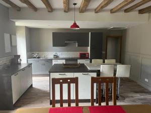 a kitchen with a table and some chairs in it at The Old Post Office Gite -Jouac in Jouac