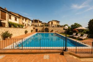 a swimming pool in front of a house at We Love Umbria in Collazzone