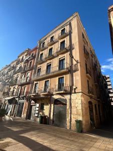 a tall building with balconies on the side of it at El balcó de la plaça de la font in Tarragona
