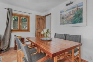 a dining room with a wooden table and chairs at Maison Magdeleine in Saint-Tropez