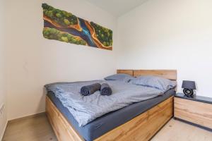 a bed with two pillows on it in a bedroom at Apartmán U mlýnu in Červená Voda