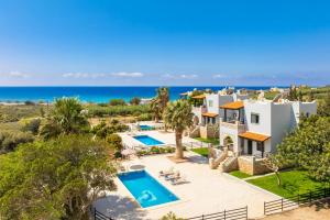 an image of a villa with a swimming pool and the ocean at Spiros Beach Villa in Frangokastello