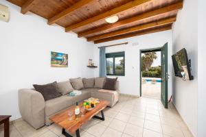 a living room with a couch and a table at Spiros Beach Villa in Frangokastello