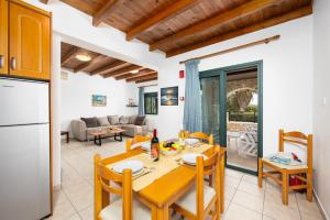 a kitchen and dining room with a table and chairs at Spiros Beach Villa in Frangokastello
