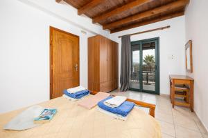 a bedroom with a bed with blue towels on it at Spiros Beach Villa in Frangokastello +20 photos