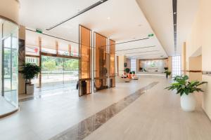 a lobby of a building with potted plants at Long Hotel in Danang