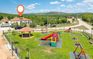 a park with a playground with a slide and swings at Villa Olivarum in Stankovci