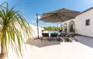 a patio with a table and chairs and an umbrella at Villa Olivarum in Stankovci