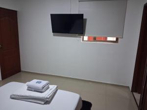 a white room with towels sitting on a table at Lumière House in Medellín +52 photos