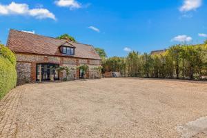an empty driveway in front of a brick building at The Coachmans Loft in Bix