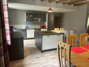 a kitchen and dining room with a table and chairs at The Old Post Office Gite -Jouac in Jouac