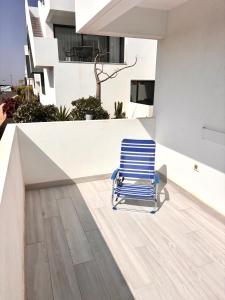 a blue chair sitting on the side of a building at Oasis in paradise with pool in La Oliva