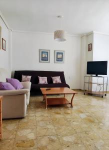 a living room with a couch and a coffee table at Paseo el Saladar in Denia