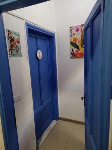 a blue door in a room with two pictures at Ël Sautafoss in Agliè