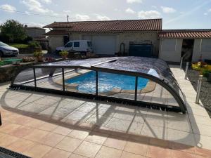 a swimming pool with a metal frame in a yard at Le Jardin de Gobelyne in Drain +7 photos