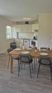 a table and chairs in a room with a kitchen at Large two bedroom apartment Athlone in Athlone