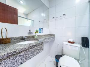 a white bathroom with a sink and a toilet at EstrelaMar Boutique in Búzios +69 photos