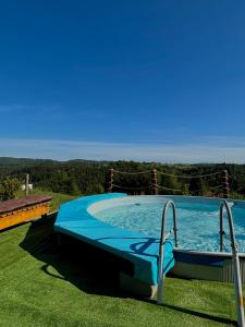 a large swimming pool in a grassy field at Domek u Małysza Istebna in Istebna