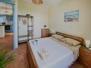 a bedroom with a bed and a room with a mirror at Casa Spezzara (tra Tropea e Capo Vaticano) in Santa Domenica
