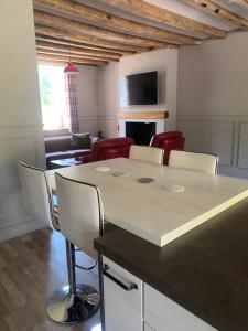 a living room with a large table and chairs at The Old Post Office Gite -Jouac in Jouac +22 photos