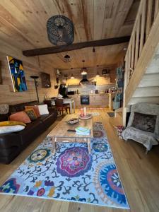 a living room with a couch and a table at le Chalet in Saint-Loup-sur-Thouet