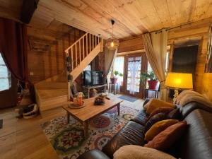 a living room with a couch and a table at le Chalet in Saint-Loup-sur-Thouet