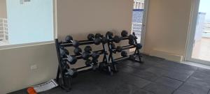 a gym with a bunch of weights in a room at New Kingston Condo Apt in Kingston