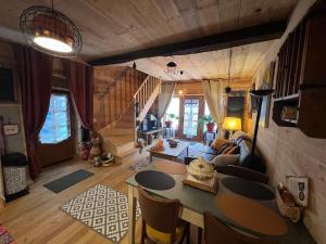 a living room with a table and chairs in a house at le Chalet in Saint-Loup-sur-Thouet