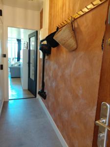 a hair dryer hanging on a wall in a hallway at Le 408 des pistes in La Bresse +9 photos