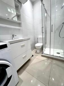 a bathroom with a shower and a sink and a toilet at Chic & Cosy in Antibes +36 photos