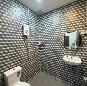 a bathroom with a toilet and a sink and a mirror at Phuket Hostel at Town in Phuket +19 photos