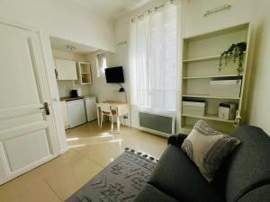 a living room with a couch and a table at Chic & Cosy in Antibes