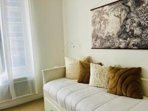 a white couch with pillows on it in a room at Chic & Cosy in Antibes