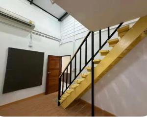 a staircase in a room with a chalkboard on the wall at Phuket Hostel at Town in Phuket