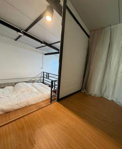 a bedroom with a bed and a balcony at Phuket Hostel at Town in Phuket