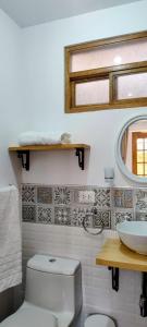 a bathroom with a toilet and a sink at Yoly's House in Caraz