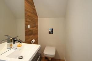 a bathroom with a white sink and a toilet at Polanki10 Łebski Dworek u Anity in Nowęcin +61 photos
