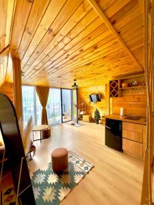 a large living room with a wooden ceiling at Alagi Cottage Kazbegi in Kazbegi